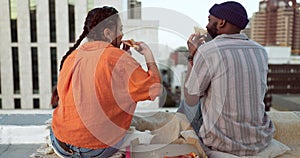 Couple, eating and pizza date on city building rooftop in New York for bonding, trust or love support. Smile, happy or