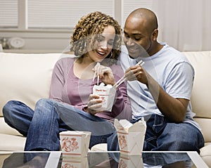 Couple eating take-out Chinese food