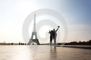 Couple at Eiffel Tower. Travelers and tourists.