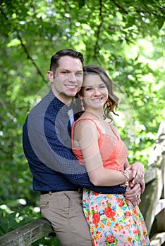 Couple embrace on bridge