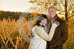 Couple embracing in autumn countryside sunset