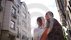 Couple embracing on the city buildings background