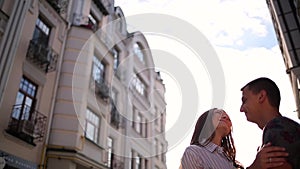 Couple embracing on the city buildings background