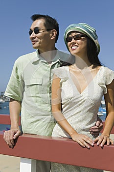 Couple embracing by railing