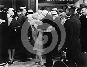 Couple embracing at a train station