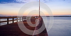 Couple At The End Of A Pier