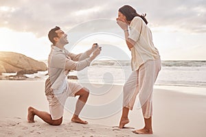 Couple, engagement proposal and surprise at beach with smile, happiness or love on vacation in sunset. Man, woman and