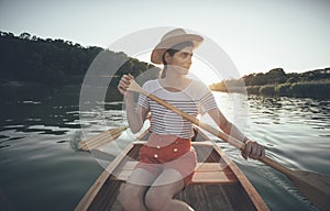 Couple enjoy canoeing, woman and man paddling boat
