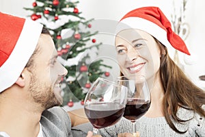 Couple enjoy chistmas with wine on sofa