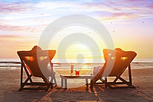 Couple enjoy luxury sunset on the beach photo