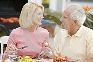 Couple Enjoying A Barbequed Meal