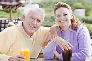 Couple Enjoying A Beverage By A Golf Course