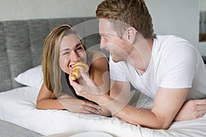 Couple enjoying breakfast in bed