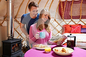 Couple Enjoying Camping Holiday In Traditional Yurt