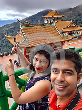 Couple enjoying at The Chin Swee Caves Temple which is a Taoist temple in Genting Highlands, Pahang, Malaysia, scenery from a top