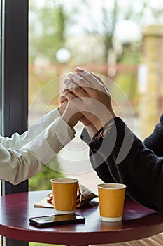 Couple enjoying a coffee holding hands