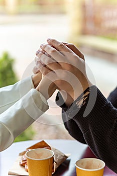 Couple enjoying a coffee holding hands