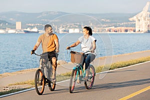 Couple enjoying a cycle ride along the seacoast