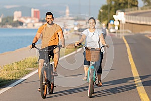 Couple enjoying a cycle ride along the seacoast