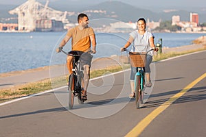 Couple enjoying a cycle ride along the seacoast