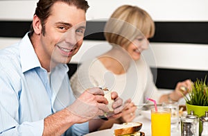 Couple enjoying delicious breakfast