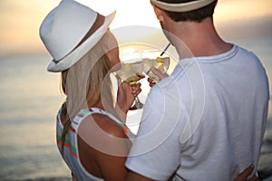 Couple enjoying drinks in sunset