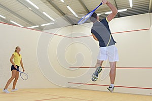 Couple enjoying game squash in squash court