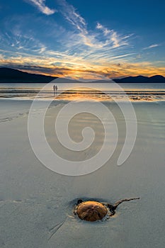 Couple enjoying gorgeous sunset on the beach. Luskentyre, Isle of Harris, Scotland.