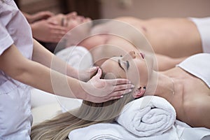 Couple enjoying head massage at the spa