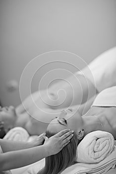 Couple enjoying head massage at the spa