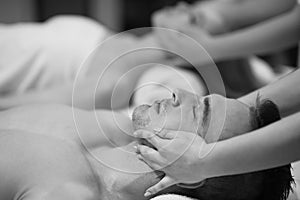 Couple enjoying head massage at the spa