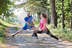 couple enjoying in a healthy lifestyle warming up and stretching before jogging