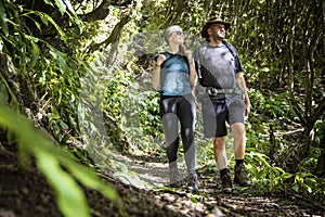 Couple enjoying a hike on a forest trail on São Jorge island in the Azores