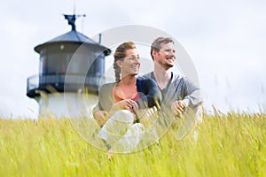 Couple enjoying holiday in front of lighthouse