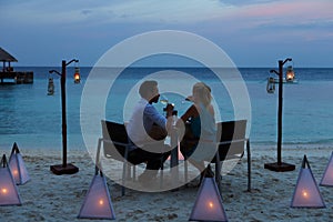 Couple Enjoying Late Meal In Outdoor Restaurant