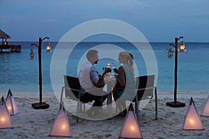 Couple Enjoying Late Meal In Outdoor Restaurant