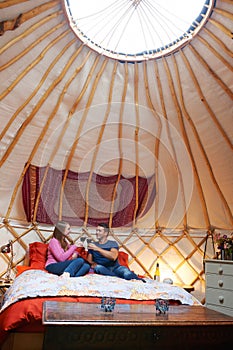 Couple Enjoying Luxury Camping Holiday In Yurt