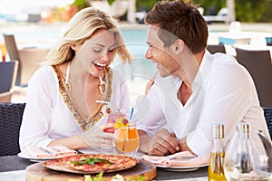 Couple Enjoying Meal In Outdoor Restaurant