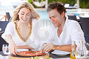 Couple Enjoying Meal In Outdoor Restaurant