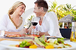 Couple Enjoying Meal In Outdoor Restaurant