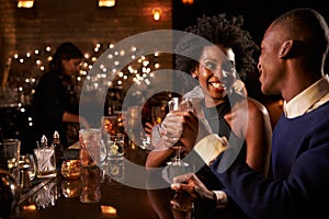 Couple Enjoying Night Out At Cocktail Bar