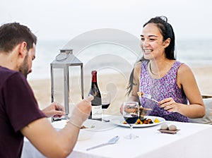 Couple enjoying a romantic dinner at the beach