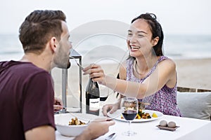 Couple enjoying a romantic dinner at the beach