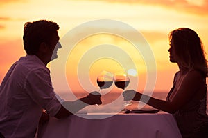 Couple enjoying romantic sunnset dinner photo