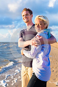 Couple enjoying romantic sunset on beach