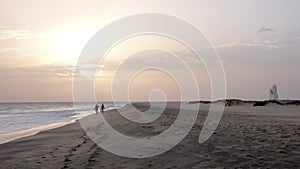 Couple enjoying a sunset walk on a secluded beach in Cape Verde