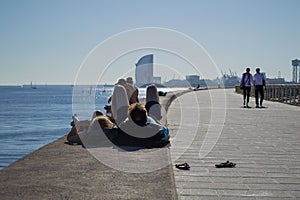 Couple Enjoying Sunshine by the Sea in Barcelona, Spain