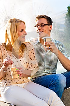 Couple enjoying take away coffee in a break