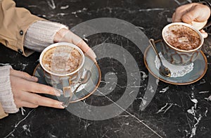 Couple enjoying tasty aromatic coffee at table