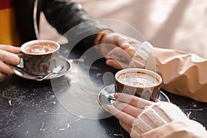 Couple enjoying tasty aromatic coffee at table